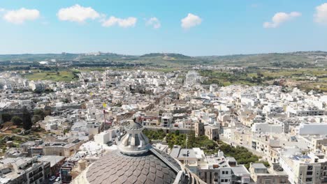 Aerial-4k-drone-footage-flying-over-the-Mosta-Rotunda-Dome-in-Malta-and-tilt-revealing-the-surrounding-city-blocks