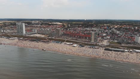 Footage-of-a-crowded-beach-along-the-North-Sea-coast-near-the-city-of-Zandoort,-Netherlands