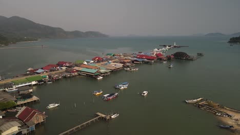 Rising-aerial-tilt-above-boats-along-the-Bang-Bao-fishing-pier-in-Koh-Chang,-Thailand