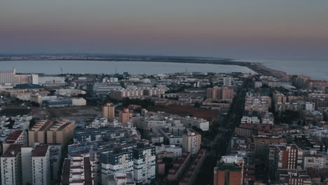 Aerial---Sunrise-over-the-Bay-of-Cadiz,-Andalusia,-Spain,-wide-shot-pan-left