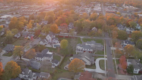 Aerial-push-forward-and-tilt-down-over-Kirkwood,-Missouri-neighborhood-at-sunset-in-the-Fall