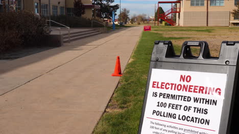 No-Electioneering-is-Permitted-Within-100-Feet-of-this-Polling-Location-Sign-with-Cone-and-sidewalk-in-Background