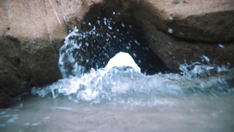 Waves-crashing-inside-of-a-cave-in-slow-motion,-Tayrona-Park,-Colombia