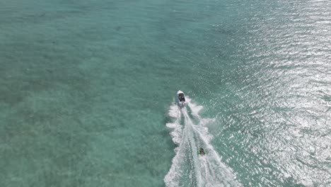 Boat-taking-Inflatable-Towable-in-ocean-In-Indian-Ocean,-Exmouth,-Western-Australia