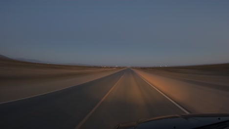 Driving-at-night-along-a-two-lane-highway-passing-cars-leaving-light-trails---point-of-view-motion-hyper-lapse