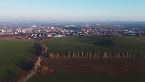 Aerial-approach-to-a-Kutna-Hora-city,-Czechia,-Europe,-on-a-sunny-spring-evening