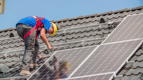 Solar-Panel-Fastening-to-Mounting-Rails-on-Sloped-Roof---Caucasian-Construction-Worker