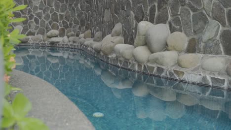 modern-swimming-pool-with-stones-and-rocks-around