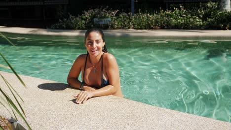 Beautiful-Woman-Smiles-At-The-Camera-After-A-Short-Dip-Into-The-Swimming-Pool-Of-Noosa-Lakes-Resort-In-Australia