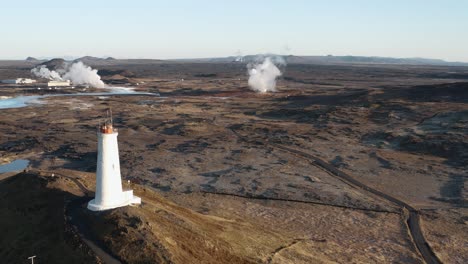 Aerial-at-Reykjanesviti-lighthouse-with-Gunnuhver-geothermal-park-in-background