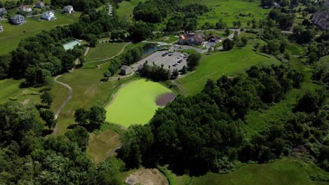 Aerial-view-of-a-banquet-house-for-celebrations-and-weddings,-surrounded-by-green-land-and-trees