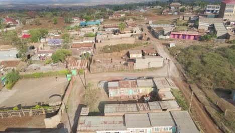 Aerial-view-following-a-settlement-through-a-small-town,-in-rural-Africa---top-down,-drone-shot