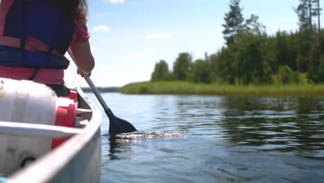 Woman-canoeing-on-Swedish-lake-in-a-sunny-day