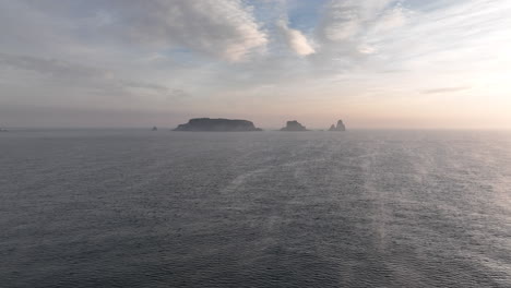 Scenic-cinematic-aerial-drone-view-of-Medas-islands-at-sunrise,-forward,-Spain