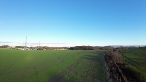 FPV-drone-flying-across-Billinge-hill-beacon-transmitter-masts-and-telephone-lines