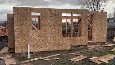 Wood-panel-walls,-windows-and-doors-under-construction