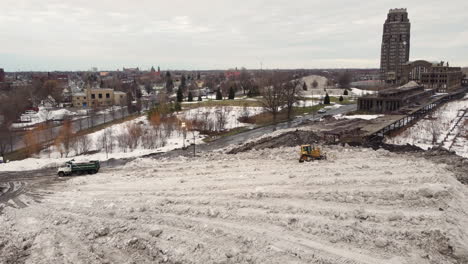 Wide-view-of-bulldozer-and-truck-at-snow-depot-after-storm-in-Buffalo
