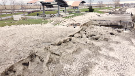 Broken-fences-and-structures-after-storm-in-snowy-Buffalo,-low-aerial