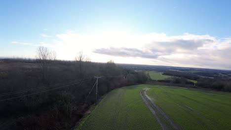 FPV-drone-flying-across-Billinge-hill-beacon-autumn-Lancashire-woodland-telephone-masts