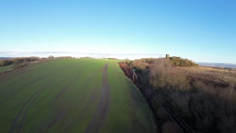 FPV-drone-soaring-across-Billinge-hill-beacon-autumn-Lancashire-farmland-landscape
