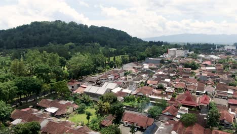 Township-near-Indonesian-jungle,-aerial-fly-above-view