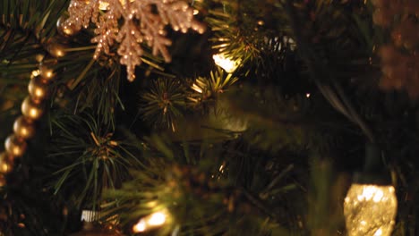 Close-up-of-ornaments-and-decorations-on-a-Christmas-Tree---Slow-Motion