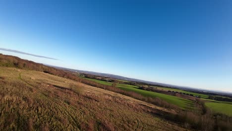 FPV-drone-flying-across-Billinge-hill-beacon-autumn-countryside-rural-scene