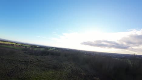 FPV-drone-flying-over-Billinge-hill-beacon-stone-circle-autumn-Lancashire-farmland-landscape