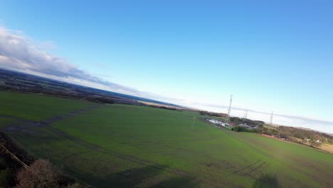 FPV-drone-flying-across-Billinge-hill-beacon-autumn-Lancashire-farmland-transmitter-masts