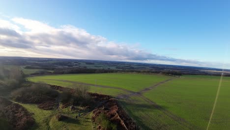 FPV-drone-flying-across-Billinge-hill-beacon-autumn-Lancashire-farmland-rural-scene