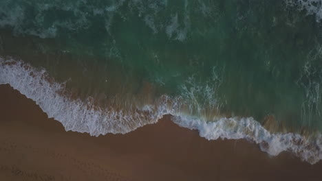 Looking-down-at-Ocean-Australia-Twelve-Apostles-Drone-Great-Ocean-Road-Melbourne-cinematic-pan-ocean-scape-with-beautiful-stunning-sunset-by-Taylor-Brant-Film