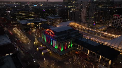 Aerial-view-of-Union-Station-in-Denver,-Colorado-lit-up-with-holiday-nights-at-night-time