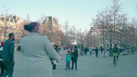 Over-population-of-people-in-the-Parisian-squares,-alternative-mobilization-of-scooter-and-bicycle,-warm-clothes-against-the-European-autumn