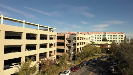 4k-Drone-rising-next-to-large-parking-structure-at-Rady's-Children-Hospital-in-San-Diego,-California