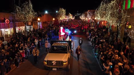 Santa-Claus-Parade,-Celebration-of-Christmas-Parade-by-Night-Along-Street-in-Denver-With-People-Crowd-on-Both-Sides-of-The-Street