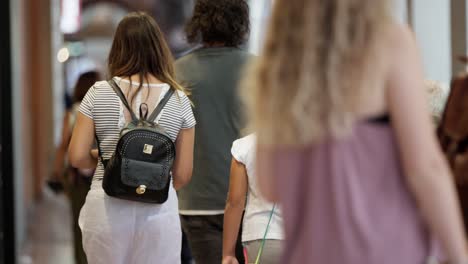 Slow-motion-scene-with-close-up-of-tourists-walking-away-from-camera