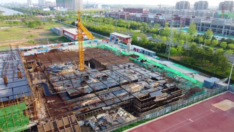 Aerial-view-towards-a-new-gymnasium-construction-site-in-sunny-Weihai,-China