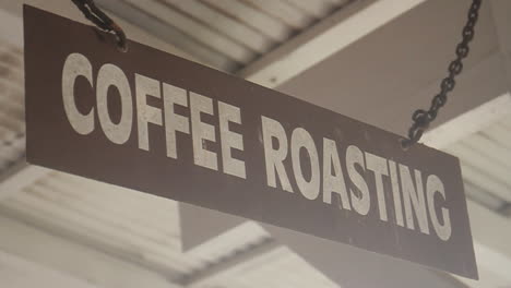 Coffee-Roasting-Sign-Hangs-from-Chain-on-Ceiling