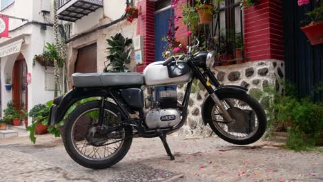 Tilt-up-shot-of-an-Ossa-motorcyle-in-a-street-of-Peñíscola