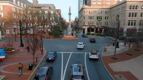 Aerial-approach-towards-statue-and-Christmas-decorations-in-town-square