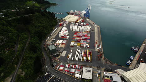 Shipping-containers-and-loading-dock-in-port-chalmers-in-dunedin,-New-Zealand