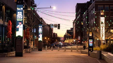 Timelapse-View-of-McGregor-Square-Pathway,-Denver-Downtown-District-at-Twilight-With-Cars-Traffic,-Lights-and-People-Walking
