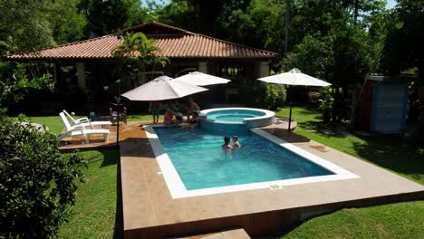 Family-enjoying-their-hot-summer-holiday-at-the-pool-while-the-boy-is-learning-how-to-swim