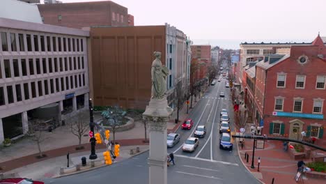 Statue-in-Lancaster-City-downtown-square,-Marriott-Hotel-and-convention-center,-aerial-drone-in-winter
