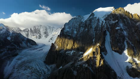 Rotating-revealing-cinematic-drone-shot-of-a-peak-in-the-Ak-sai-glacier-in-Kyrgyzstan
