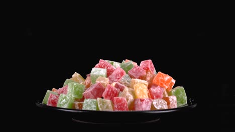 Vibrant-colourful-assortment-of-Turkish-Delight-Sweets-against-black-background