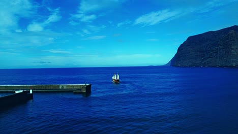 Stunning-Shot-Unveiling-Boat-Sailing-From-Marina-To-Open-Blue-Ocean,-Tenerife,-Spain