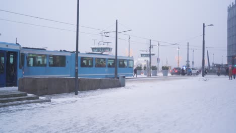 People-Walking-Along-The-Promenade-At-Aker-Brygge-In-Oslo-During-Winter-Snow-Fall