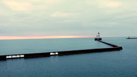 hyperlapse-of-Milwaukee-breakwater-light,-captured-at-sunrise,-historical-landmark-in-Wisconsin,-cinematic-shot
