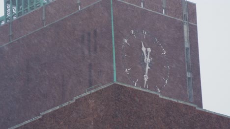 Heavy-Snow-Falling-With-View-Of-Clock-Face-On-Oslo-City-Hall-And-Birds-Flying-Past